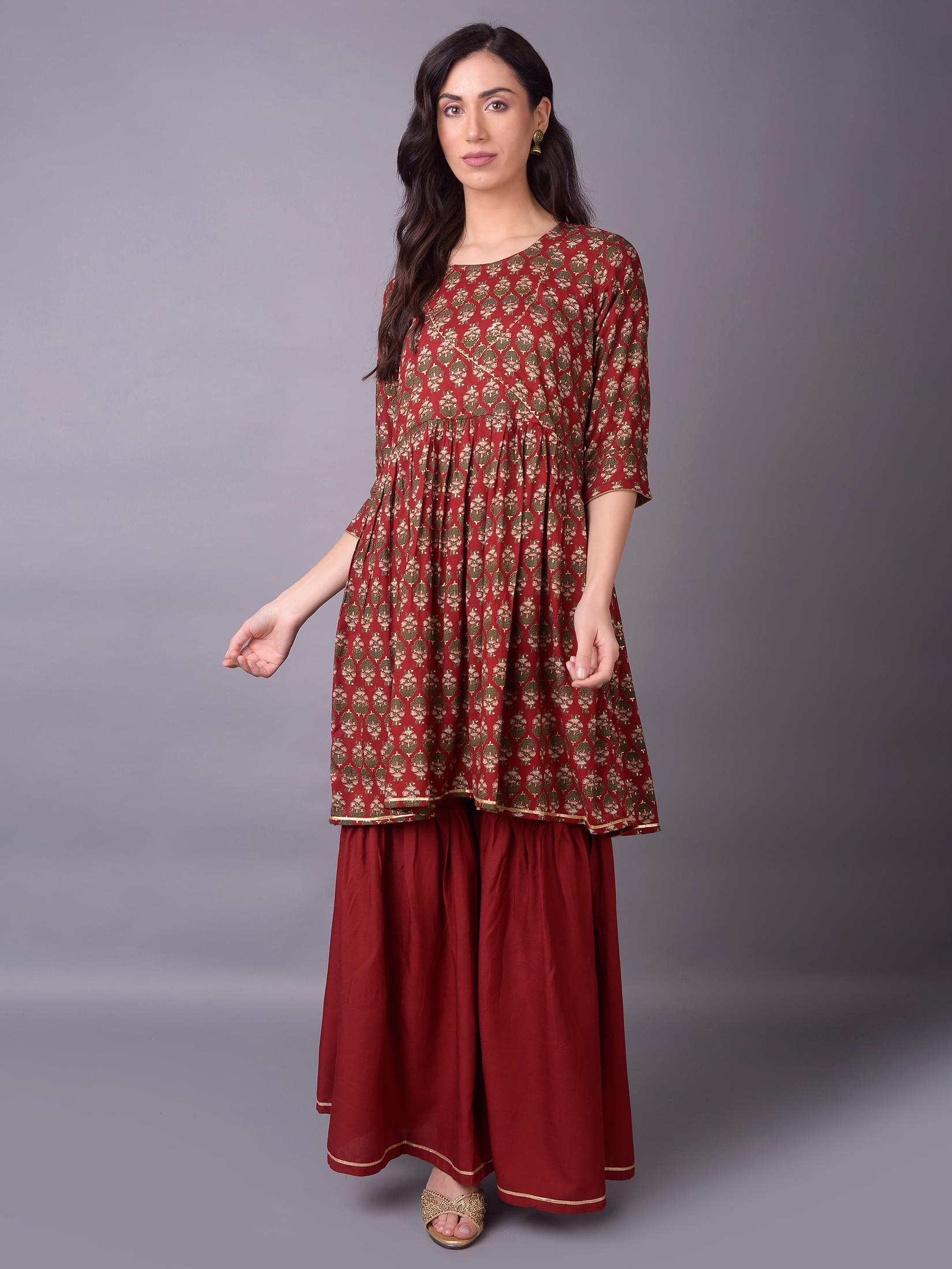 Women Maroon Ornamental Printed Kurta With Sharara Pant.