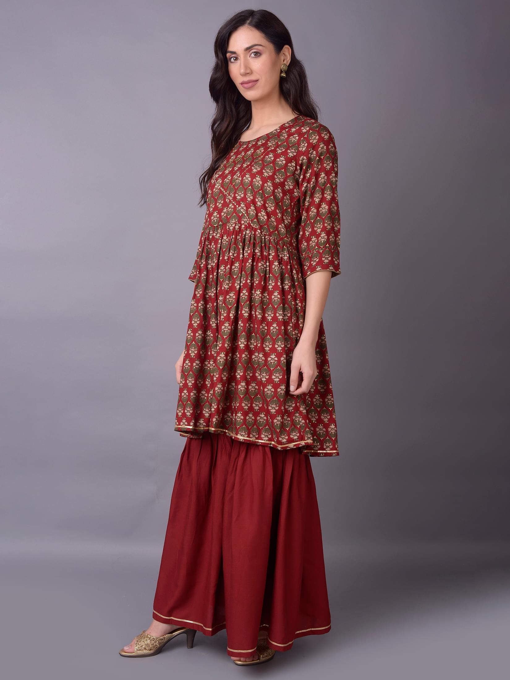 Women Maroon Ornamental Printed Kurta With Sharara Pant.