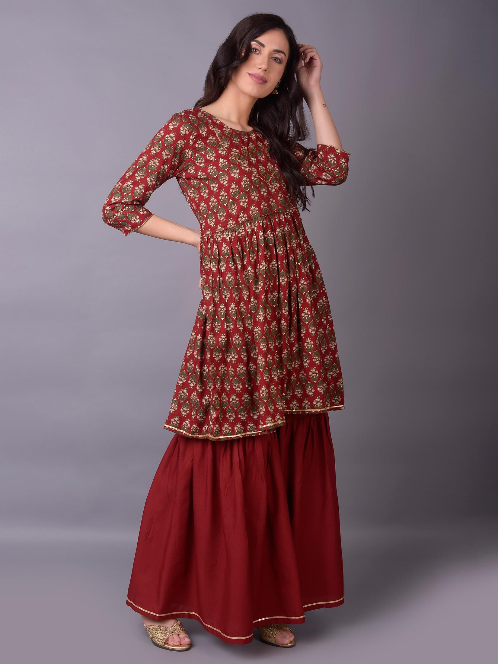 Women Maroon Ornamental Printed Kurta With Sharara Pant.
