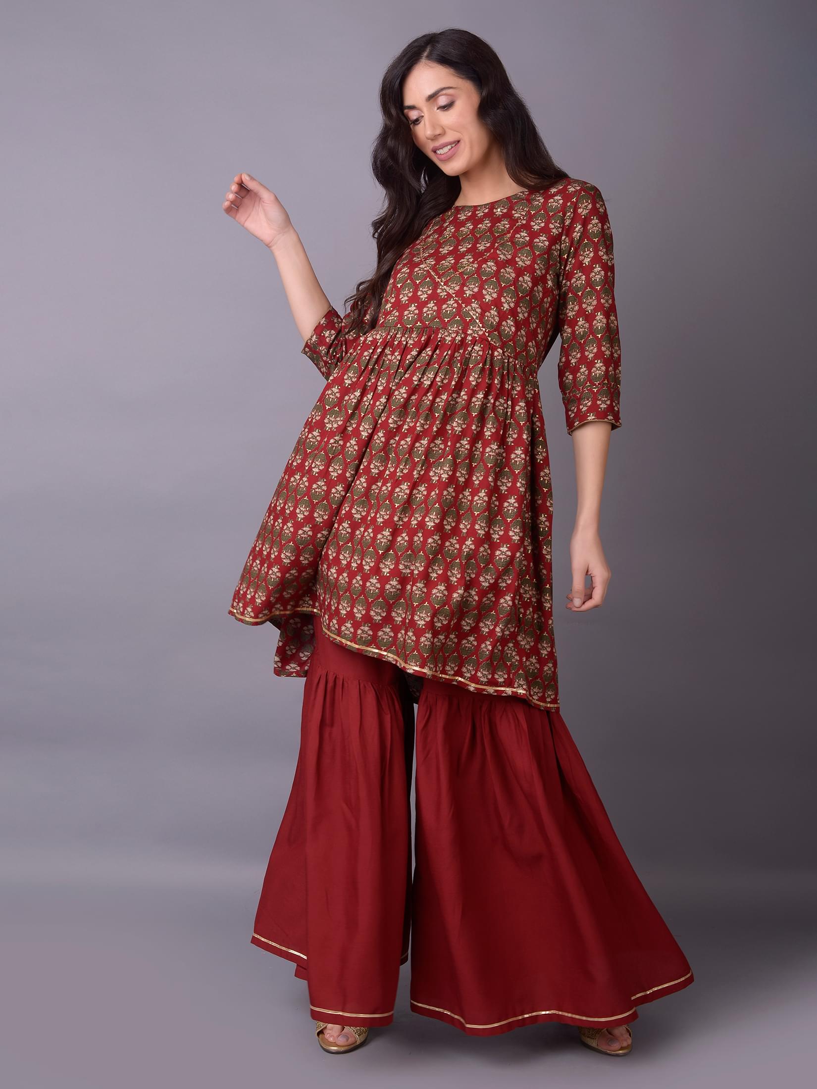 Women Maroon Ornamental Printed Kurta With Sharara Pant.